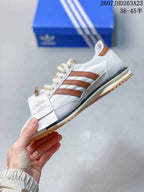 Side profile highlighting the white upper, brown three stripes, cream midsole and gum outsole.