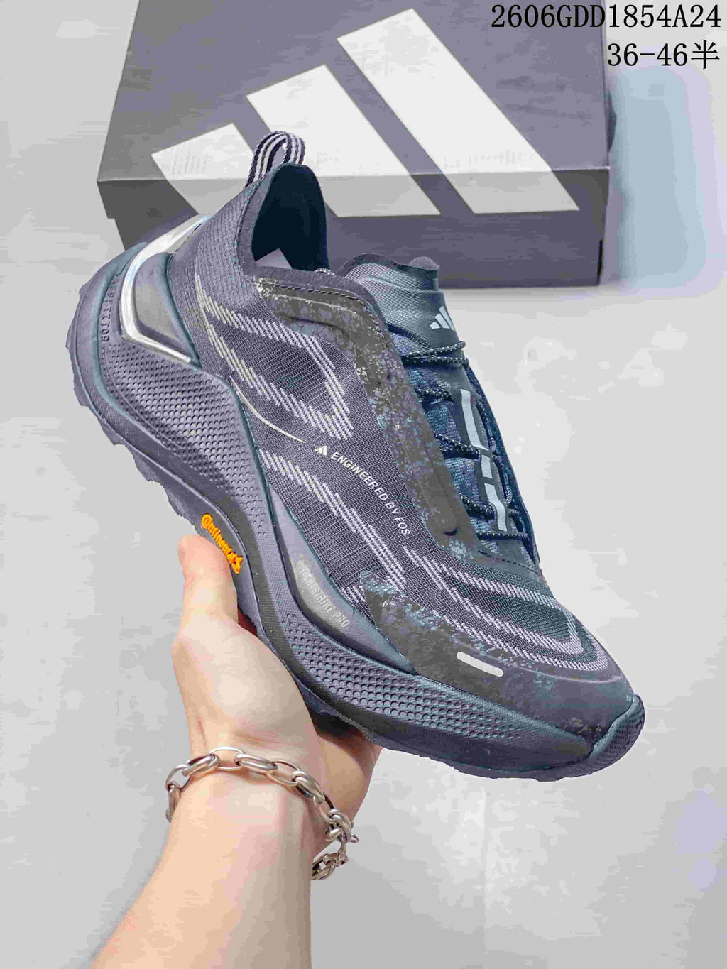Angled side view of a dark gray Adidas Holo Peak shoe