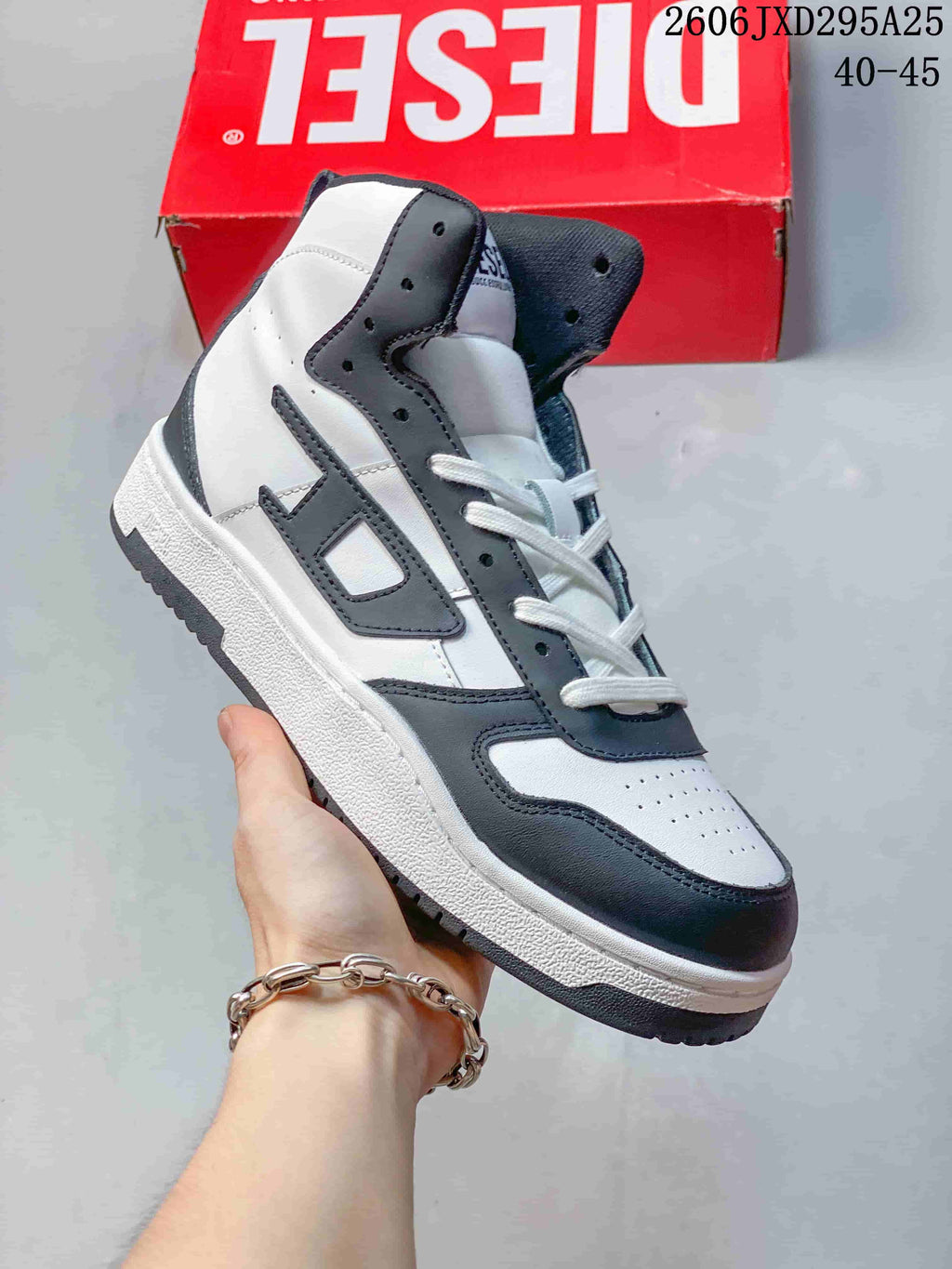 Angled side view of a white and dark gray Diesel high-top sneaker