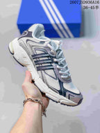 White and gray adidas Response CL sneaker with dark navy side stripes and mesh-style panels.