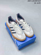Pair of white adidas low-top sneakers with navy stripes and gum outsoles displayed on a blue shoebox; overlay shows style code 2607JJD1087A27 and size range 35–45.5.