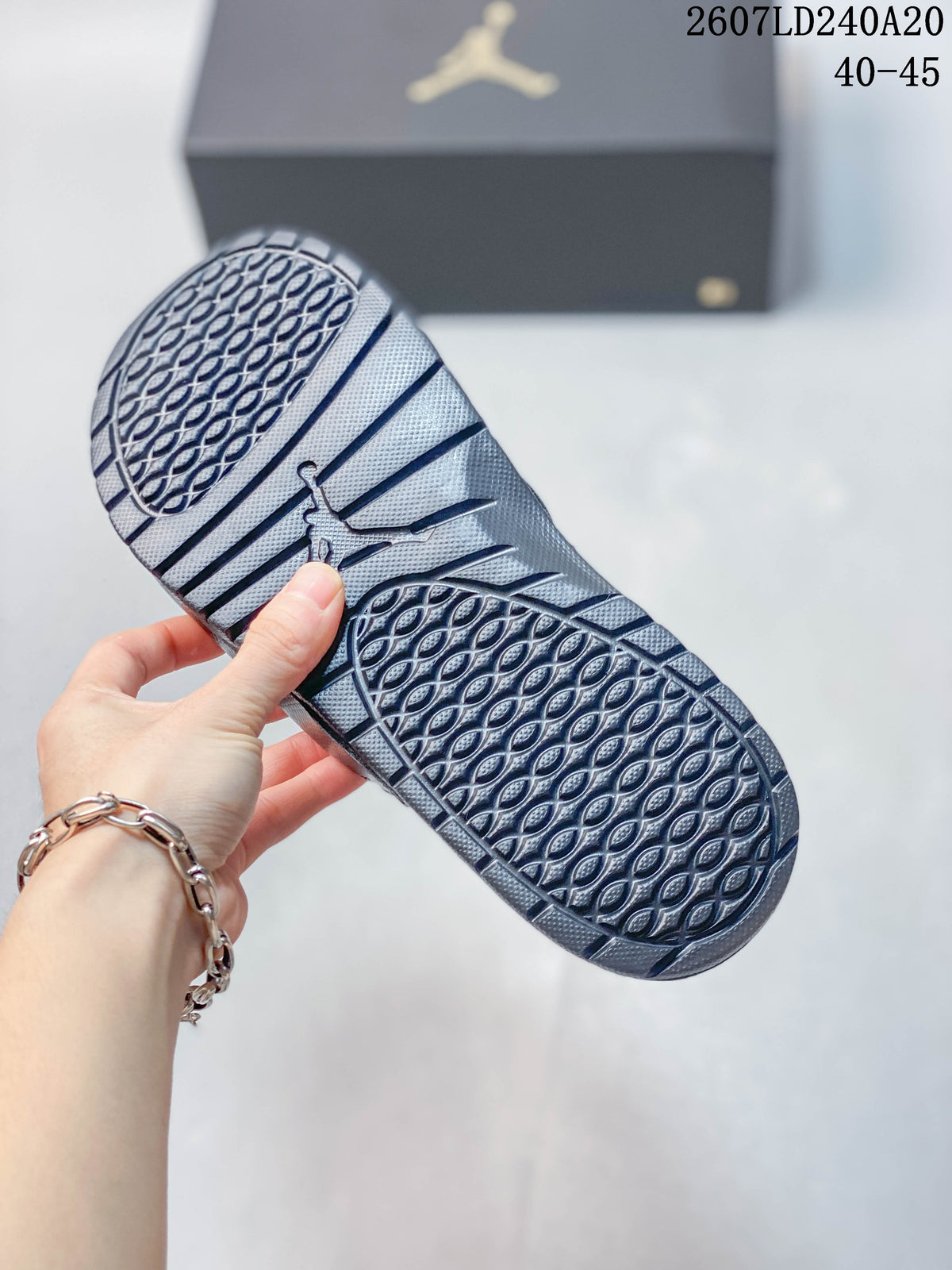 Underside of a Jordan slide showing the patterned outsole and textured traction areas; style code 2607LD240A20 and size range 40–45 appear above.