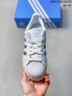 Front view showing the lace-up design, shell toe, and adidas tongue label.