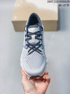 Top view of the sneaker showing the perforated knit-style toe area, navy laces, and branded tongue.