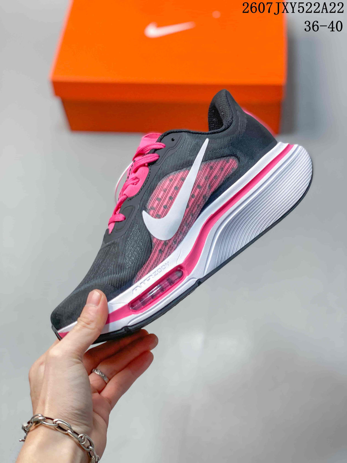 Side view showing the white swoosh, pink mesh side panel, and layered midsole.