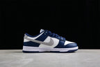 Side profile showing the low-top silhouette, gray Swoosh, navy overlays, and white midsole.