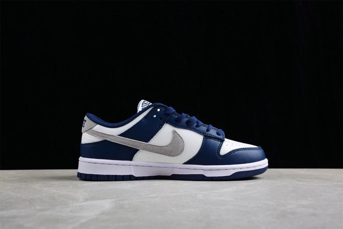 Side profile showing the low-top silhouette, gray Swoosh, navy overlays, and white midsole.