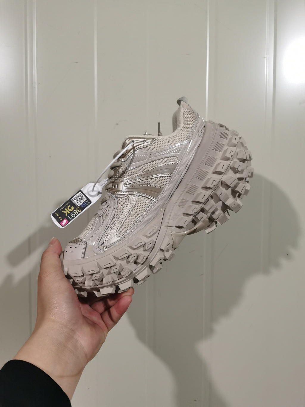 Side view of a beige 9700 Defender sneaker showing the mesh upper, layered overlays, and chunky lugged outsole.