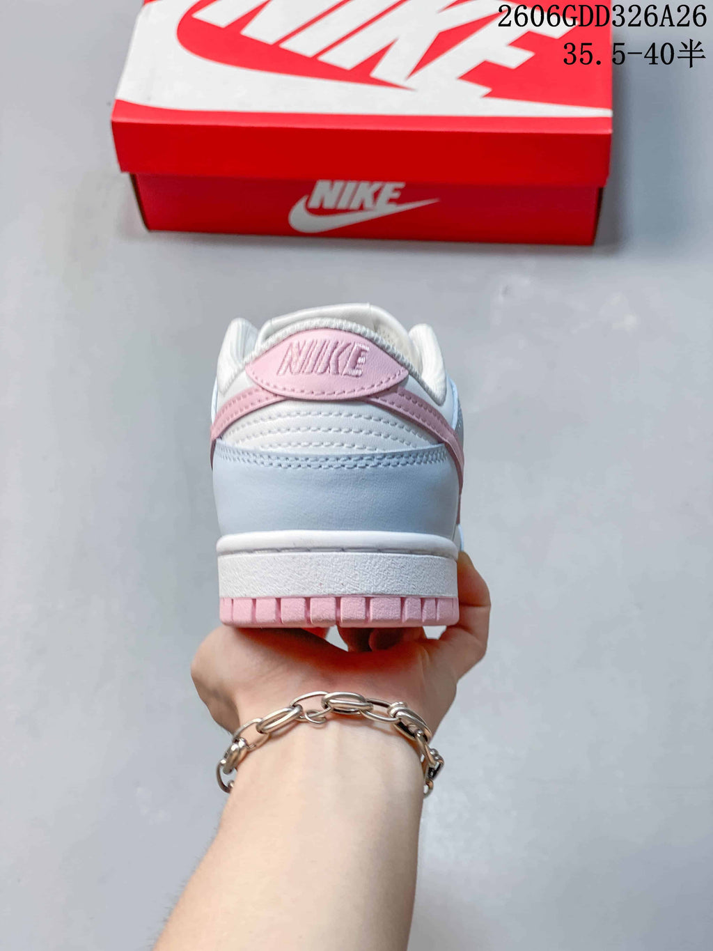 Rear view of the sneaker showing pale blue and pink heel details