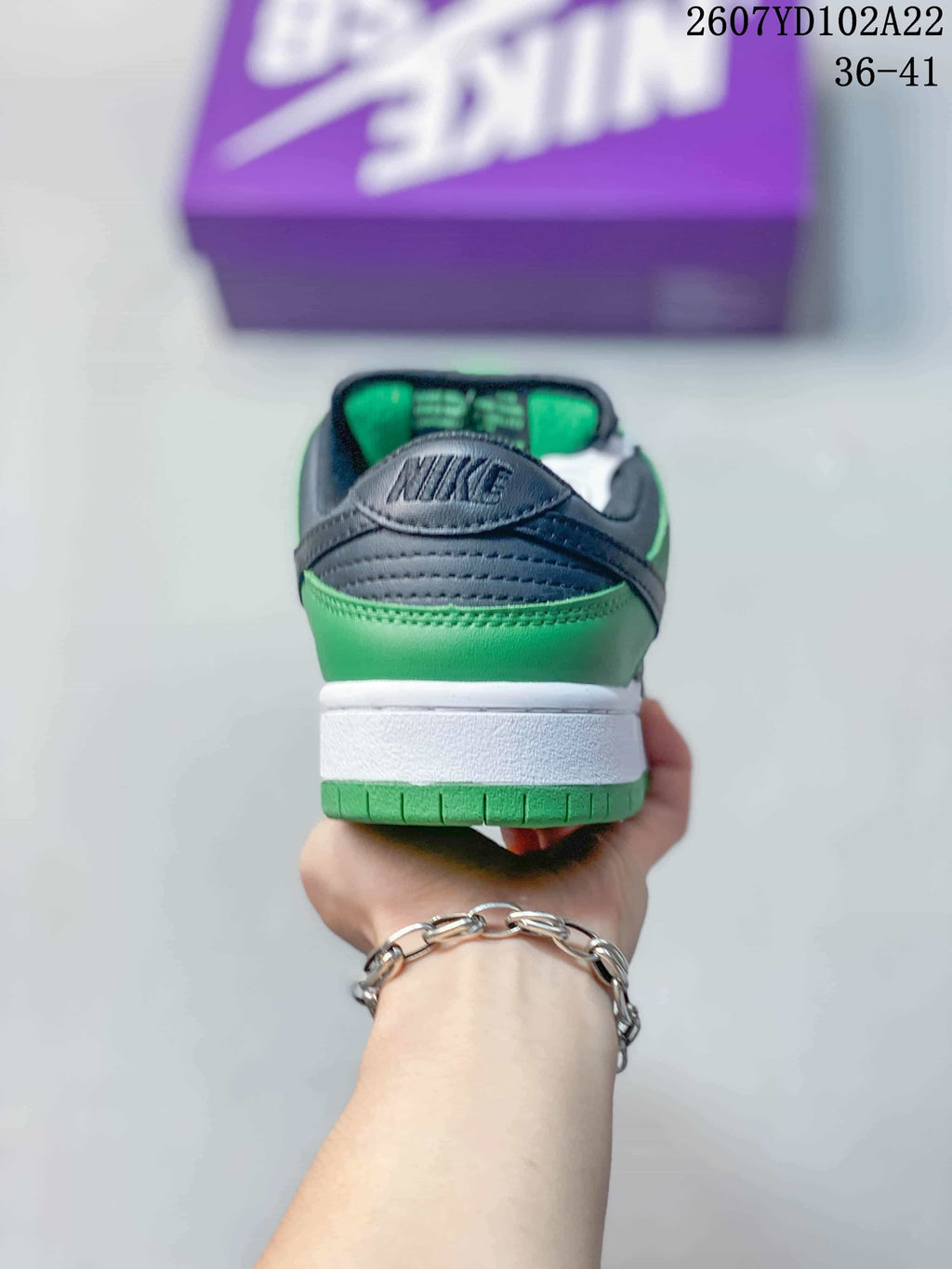 Rear view showing the green heel panel, dark padded collar and white midsole.