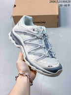 Angled side view of a white and gray Salomon XT-Quest ATHR sneaker.