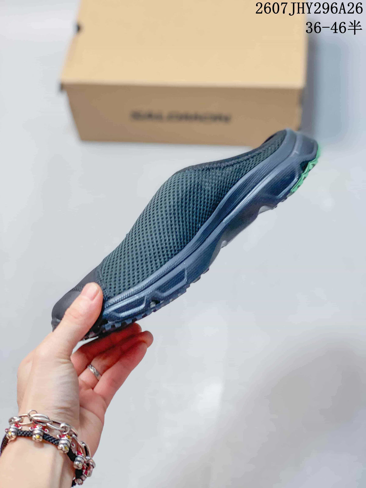 Side profile showing the black mesh upper, closed toe, slip-on construction, and textured outsole.
