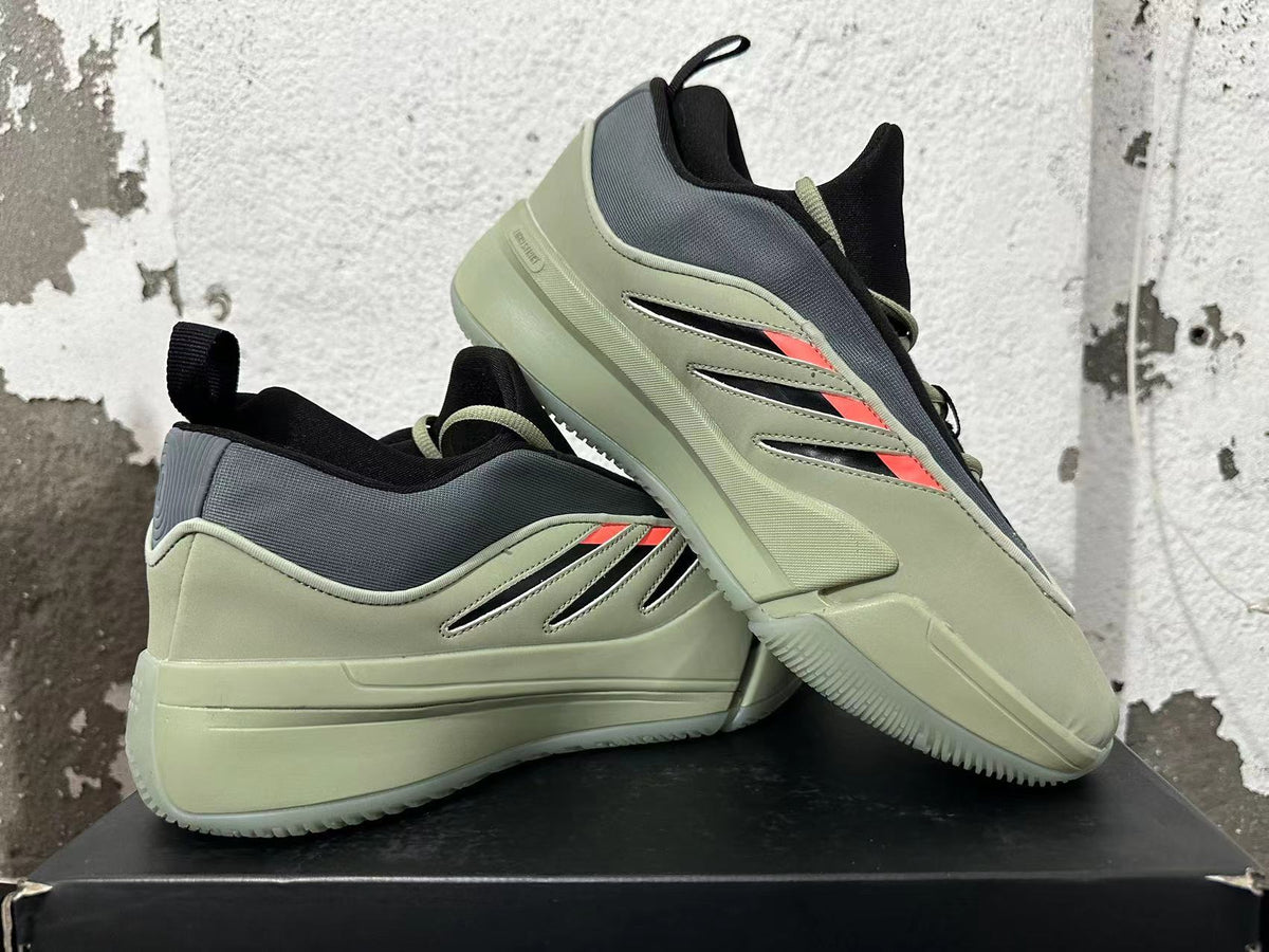Pair of green, grey and orange adidas Dame 9 basketball shoes shown from the side.