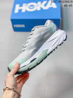 Side profile of the gray and mint low-top running shoe with a white midsole and textured upper.
