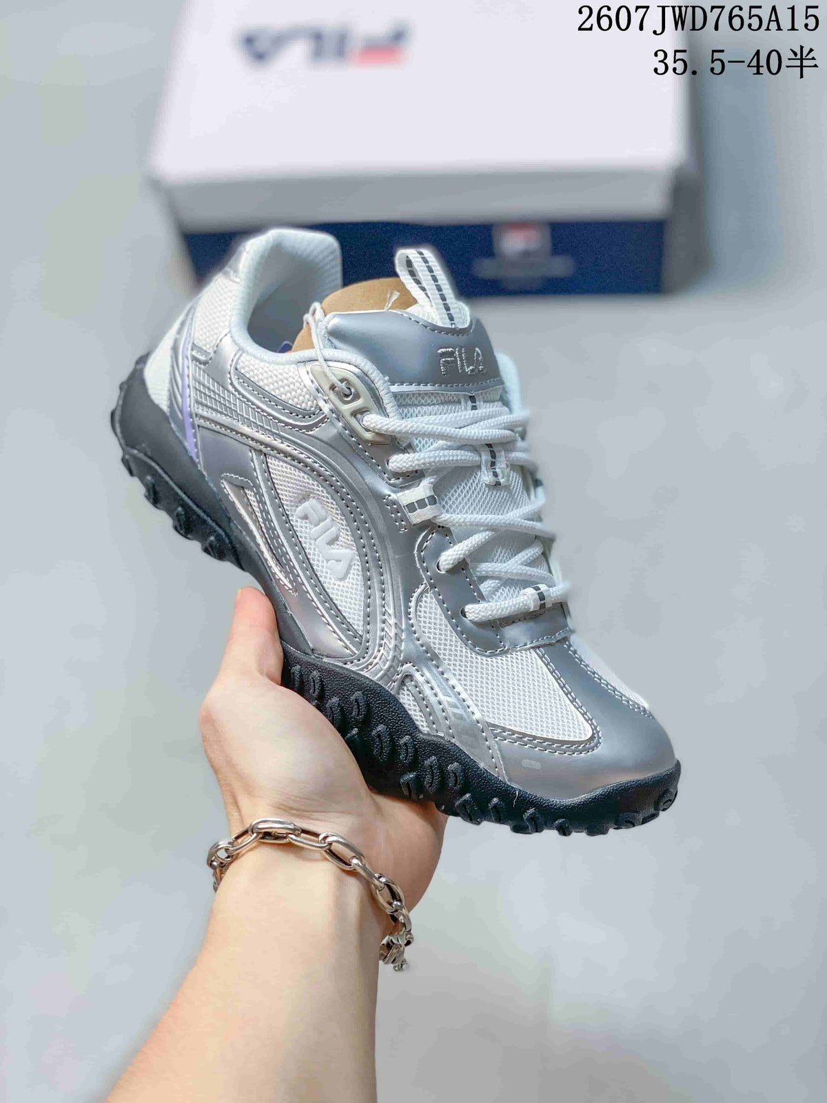 Three-quarter side view highlighting the silver and white upper construction and black outsole.