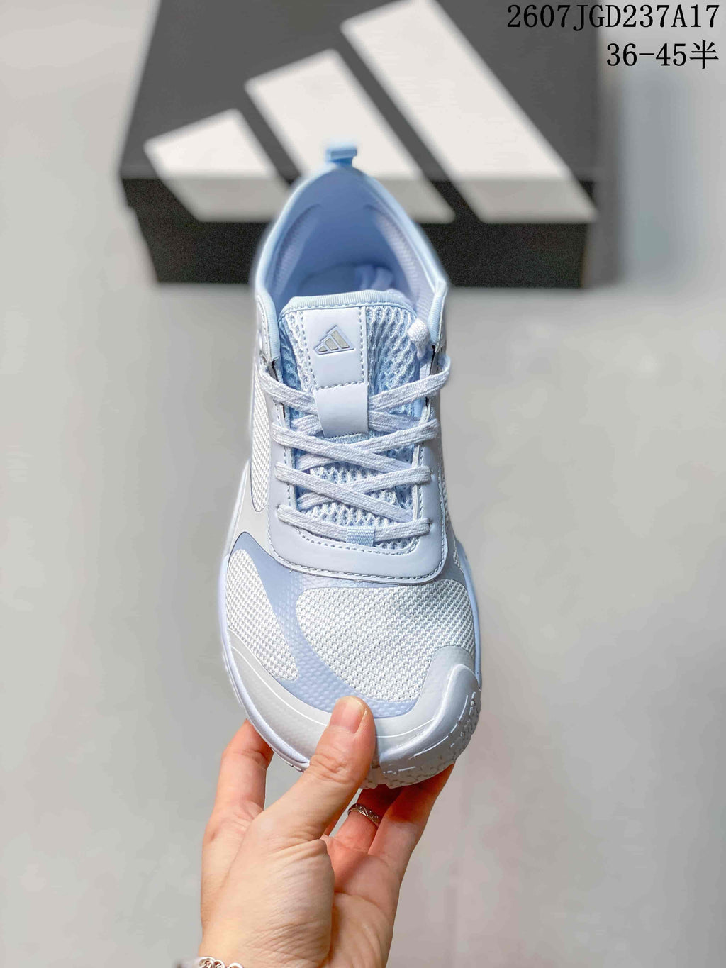 Top view of one crystal blue sneaker showing the lace-up closure, tongue branding and mesh-look toe area.