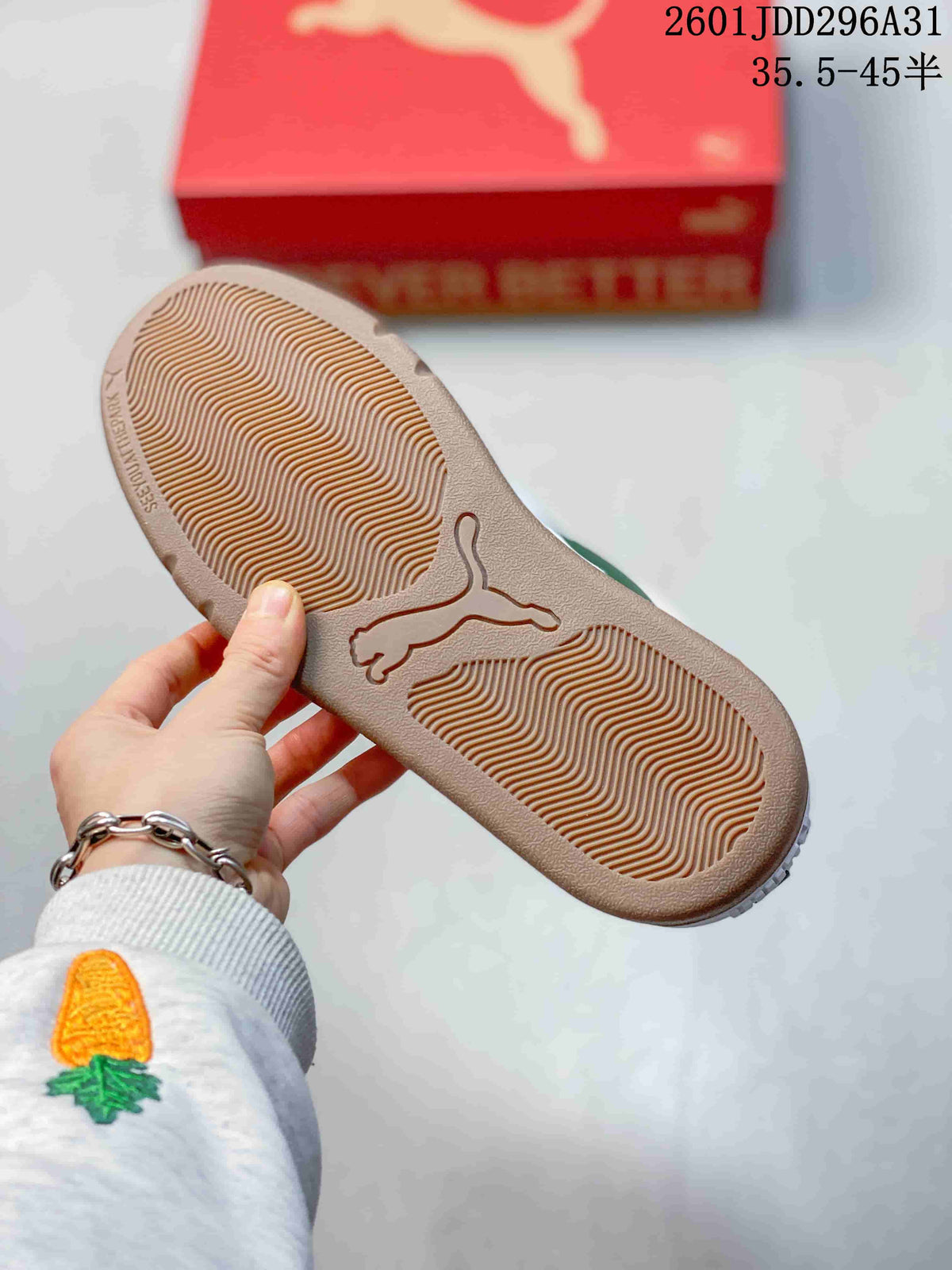Underside of a PUMA sneaker showing a textured brown-toned outsole and central PUMA cat logo.
