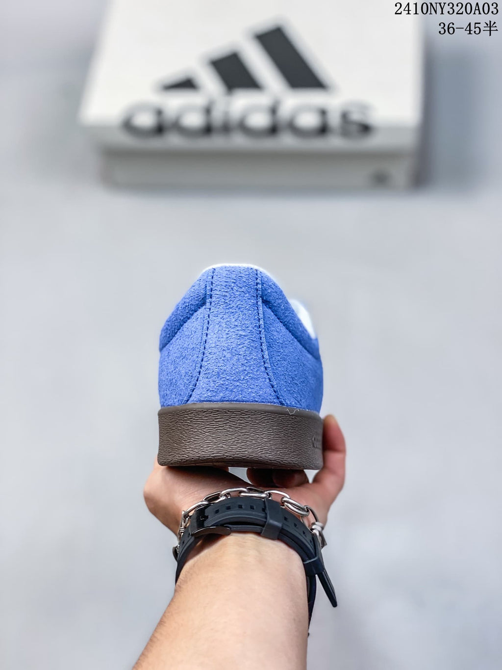Rear view of the blue low-top sneaker with a brown outsole and padded collar.