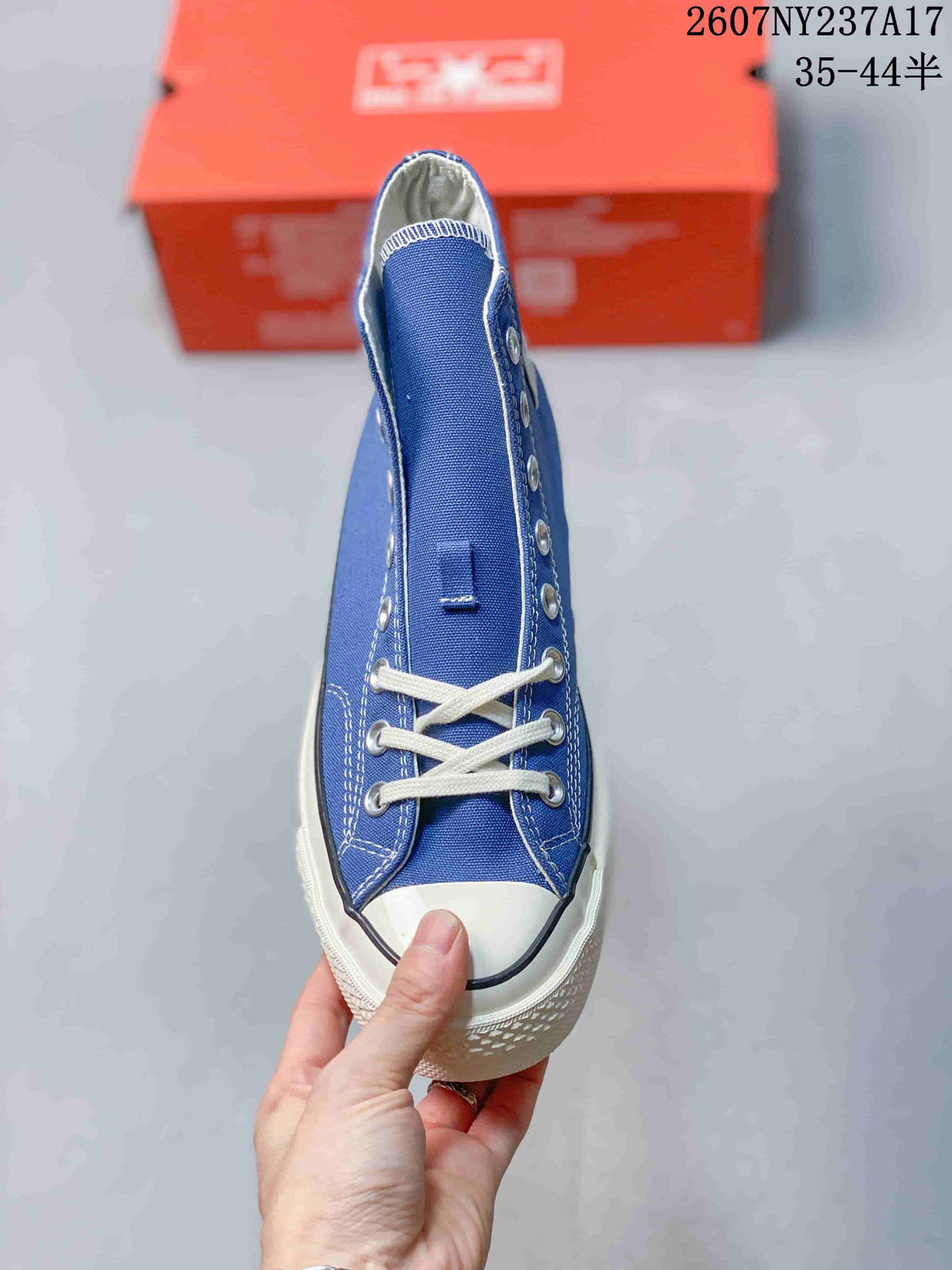 Top view of the blue high-top sneaker showing the lacing, white toe cap, and contrast stitching.