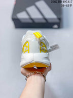Rear view showing the padded heel, yellow structural details, and segmented outsole.