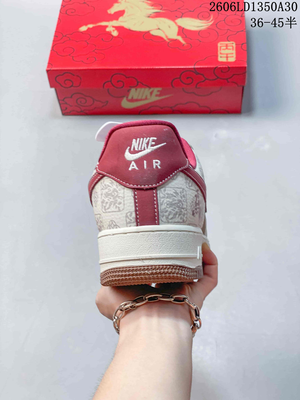 Rear view showing the patterned heel, red heel tab, and cream midsole