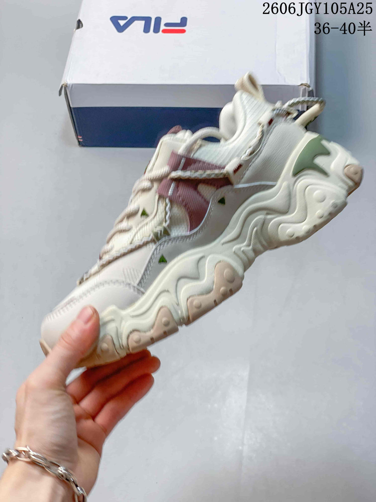 Side profile of a cream FILA Fusion chunky sneaker with mauve and green details
