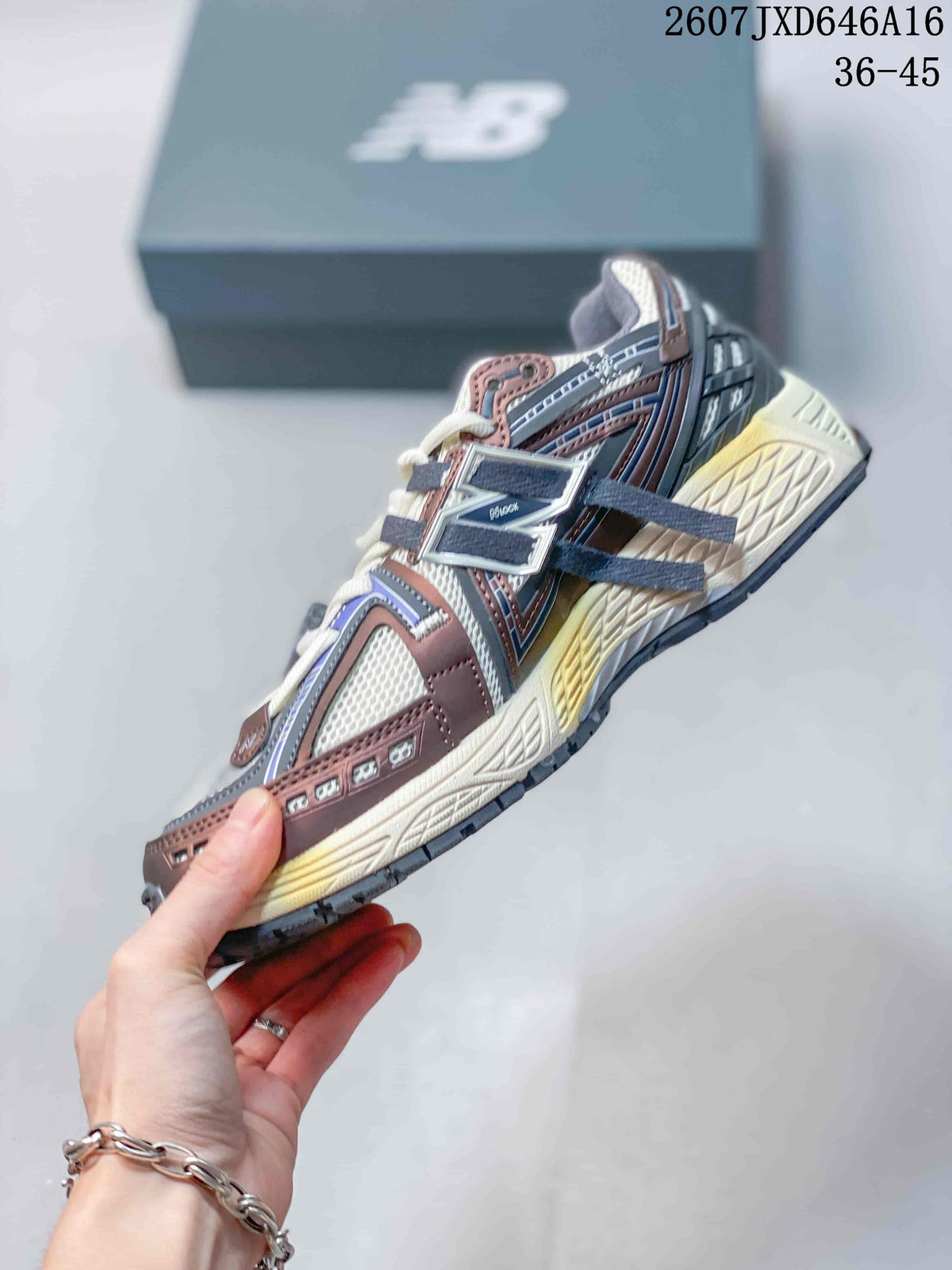 Side view of a New Balance 1906A sneaker showing the layered panels, logo and contrasting midsole details.