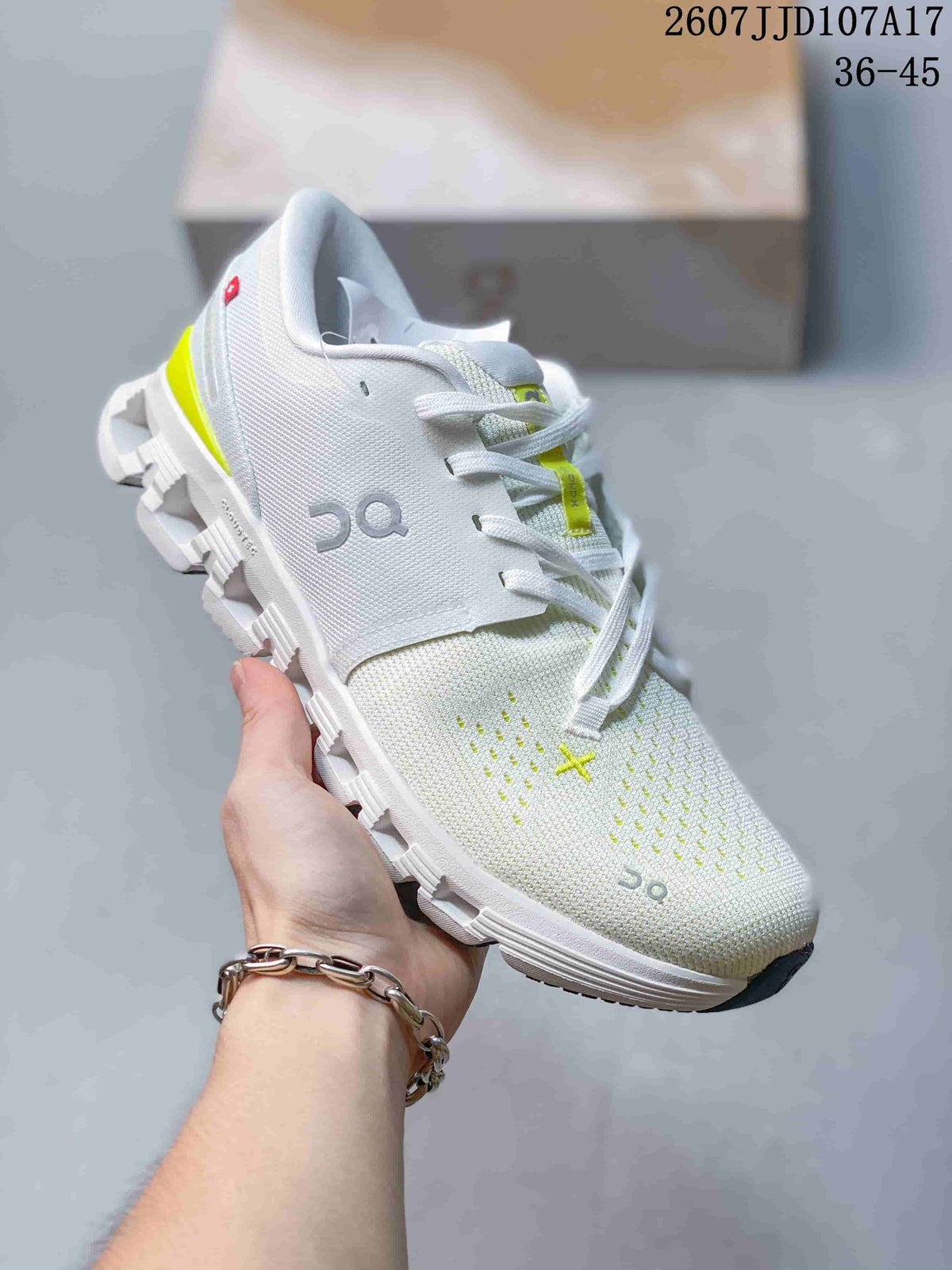 Angled side view of the white and lime On Running sneaker showing the upper, heel accent, laces, and outsole structure.