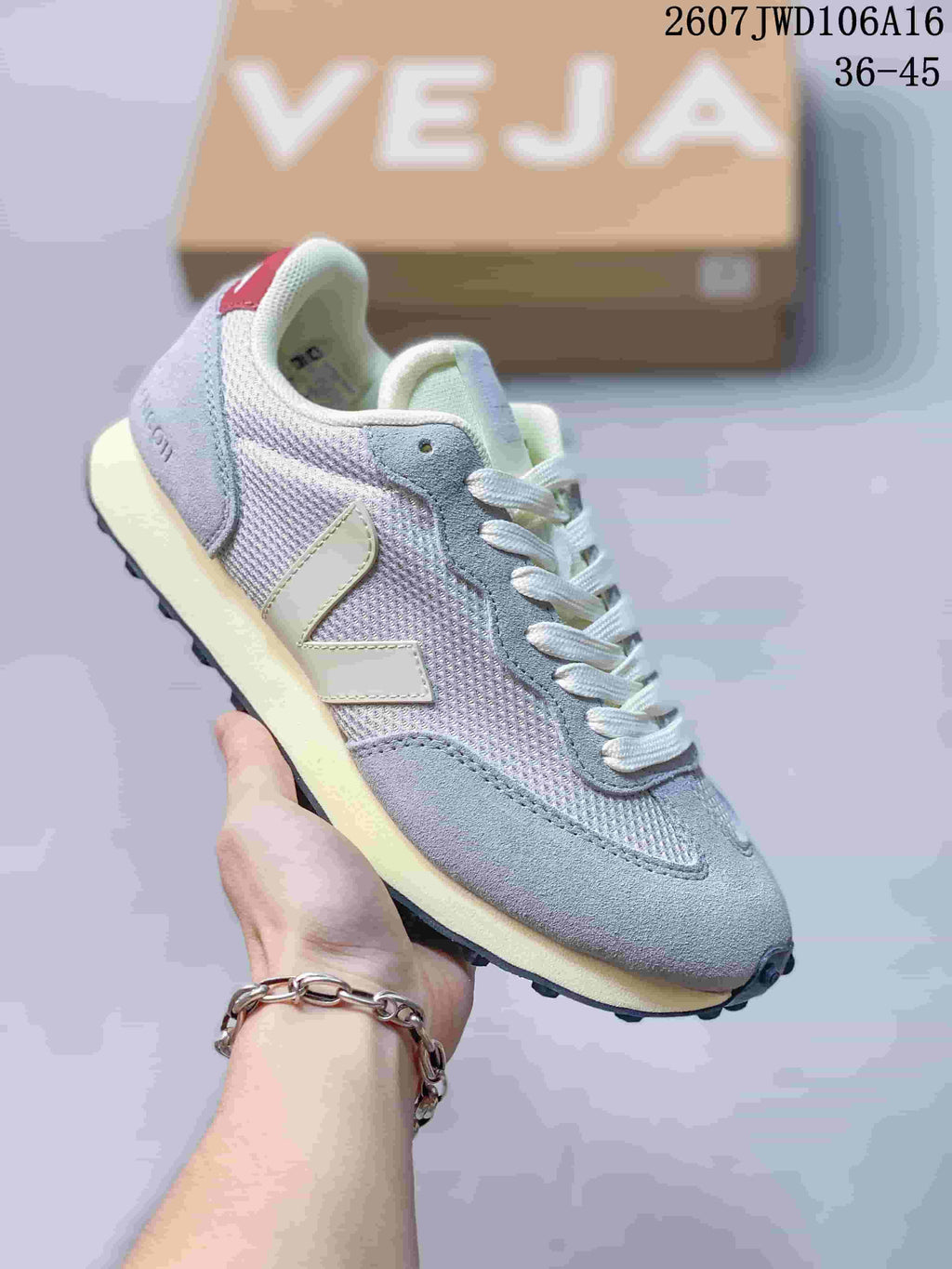 Light gray and pastel VEJA Rio Branco sneaker with white laces and contrasting V branding.