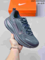 Dark Nike Structure Plus running sneaker with a matching dark upper and midsole.