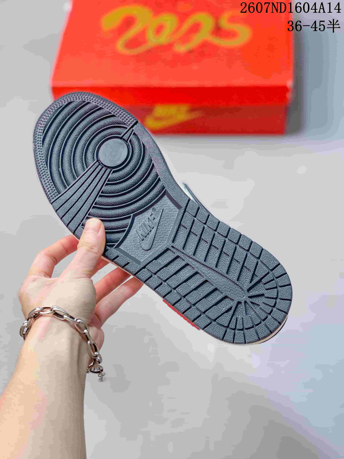 Close-up of the dark textured rubber outsole with circular and grid traction patterns; a red presentation box is in the background.