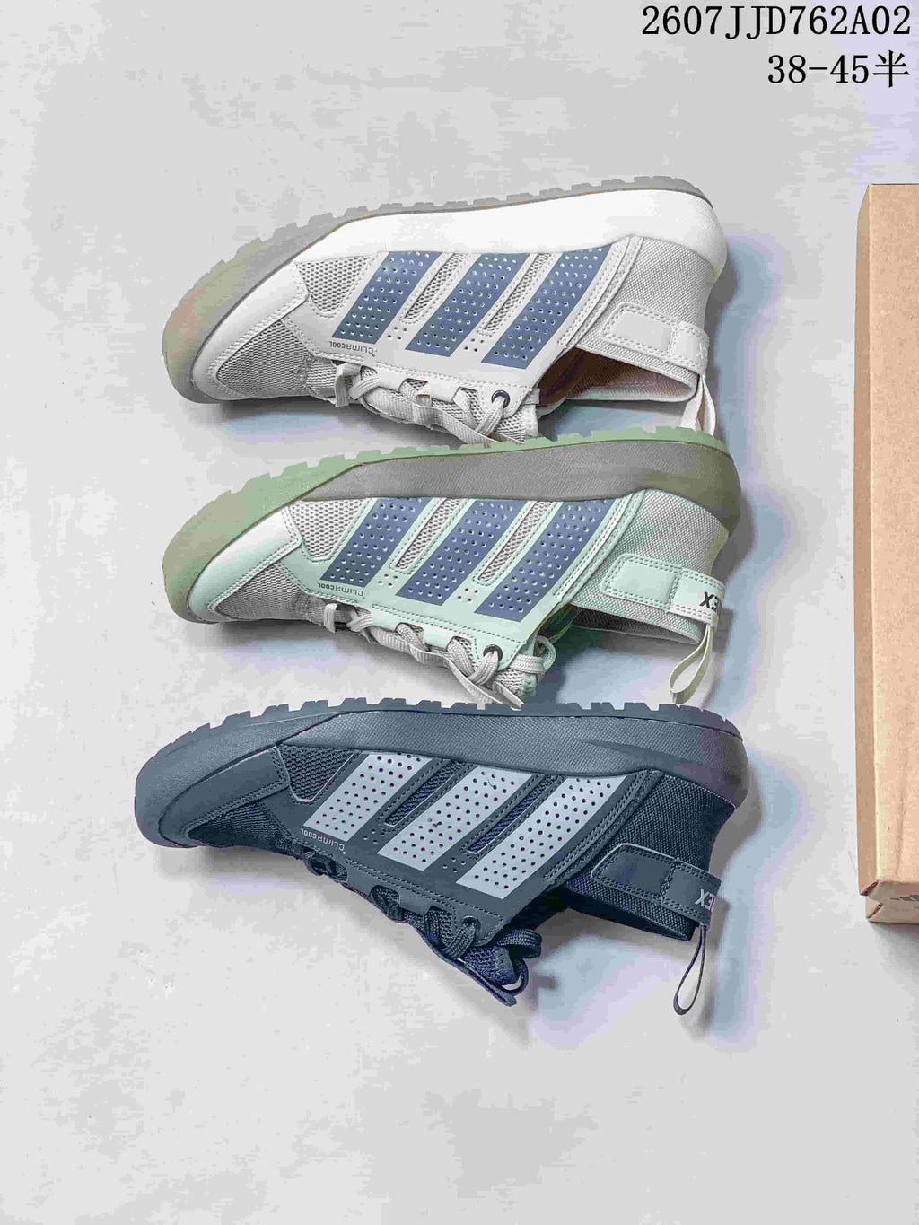 Adidas Terrex Daroga 25 shoes in light grey, pale green, and dark grey, shown from the side.
