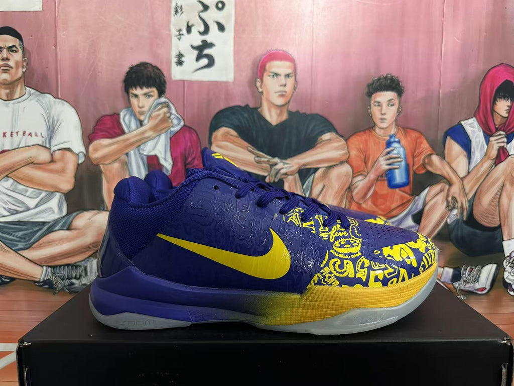 Side view of a blue and yellow Nike basketball sneaker showing the yellow Swoosh, patterned upper, and translucent outsole.