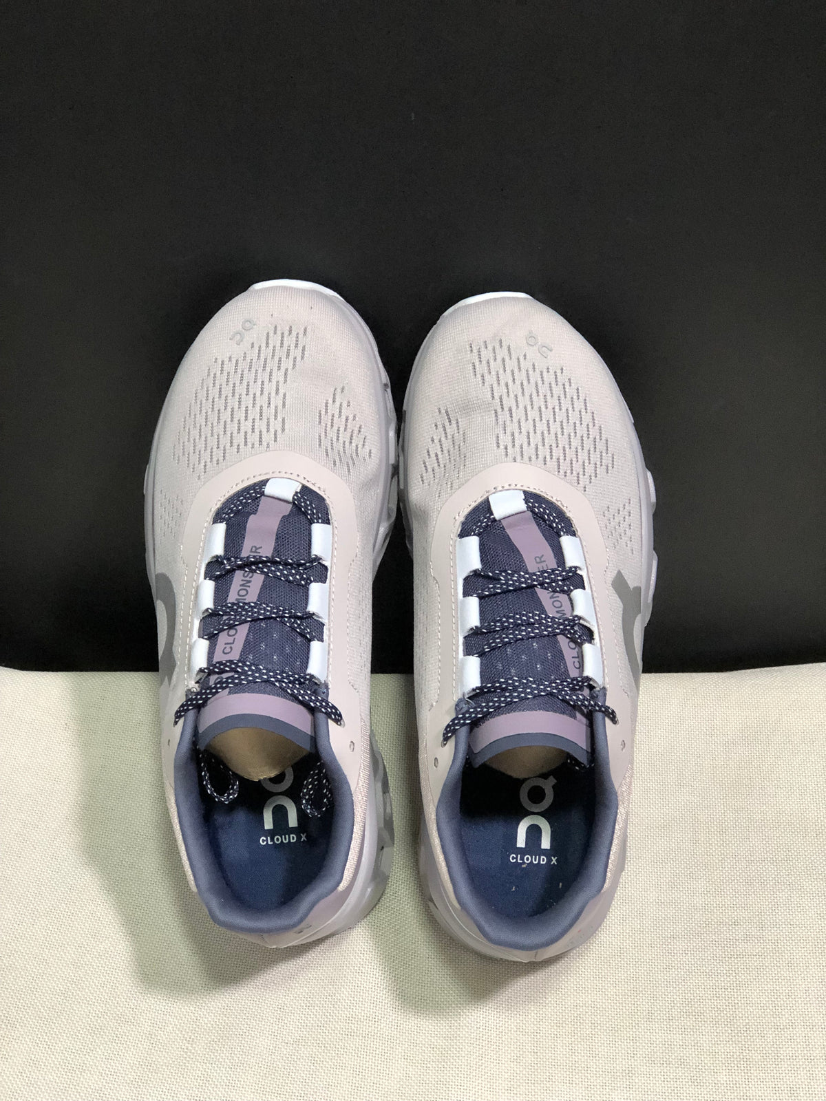 Top view of the On Cloud X sneakers with patterned laces and branded insoles