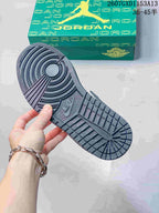 Close view of the textured outsole showing circular forefoot traction and rectangular tread sections.