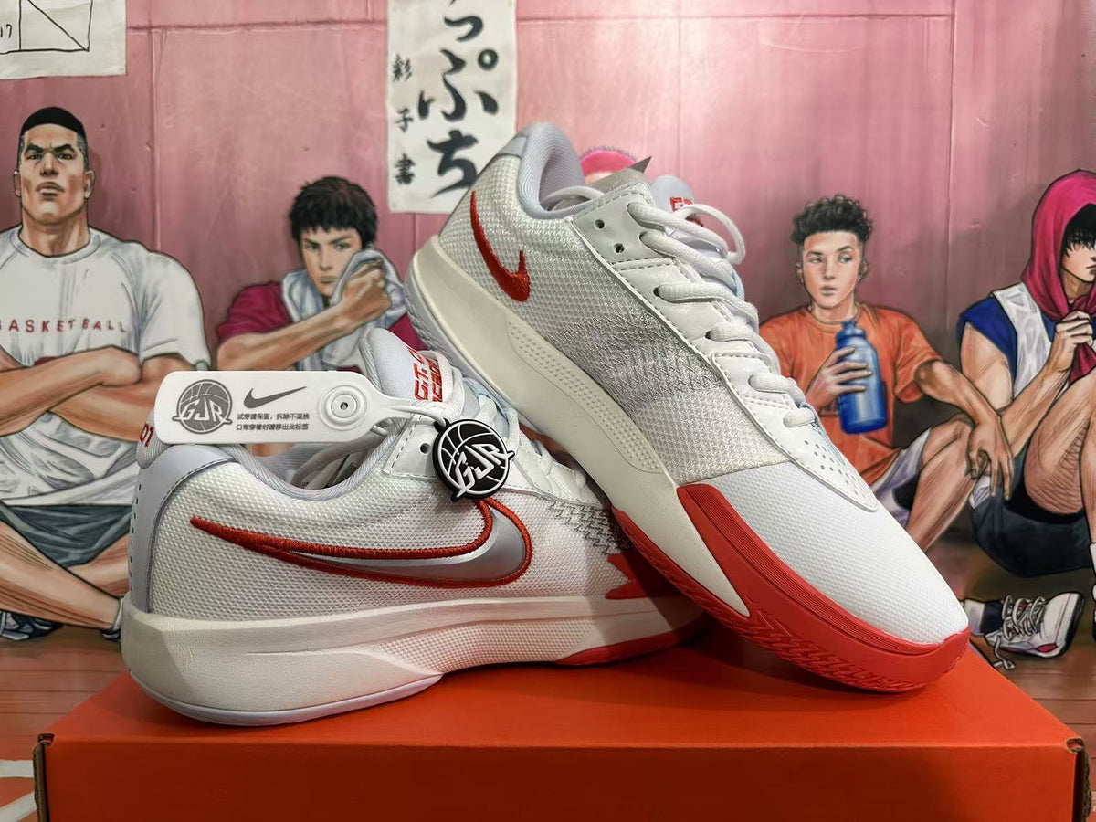 Angled view of white Nike GT Cut 3 basketball shoes showing red outsole details and side branding.