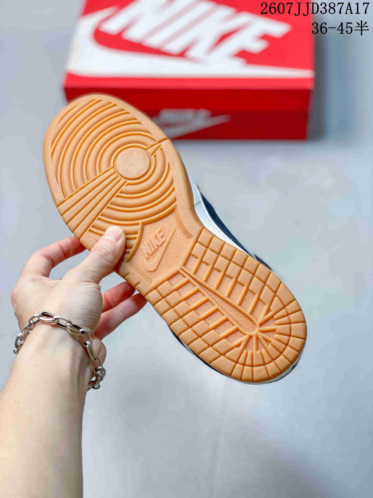 Close-up of the gum-colored outsole with circular and grid traction patterns and a molded Nike Swoosh mark.