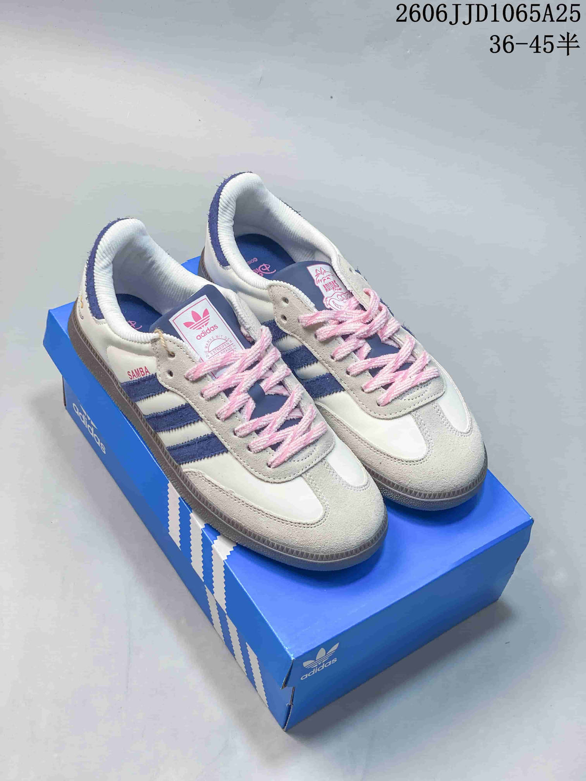 White low-top sneakers with blue stripes, pink laces and light suede-look overlays