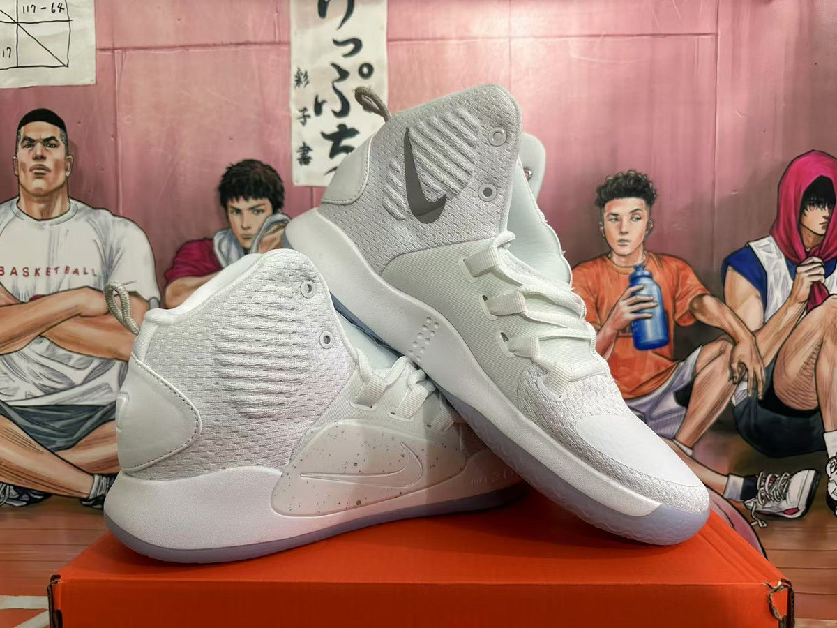 Angled view of white and silver Nike high-top basketball shoes