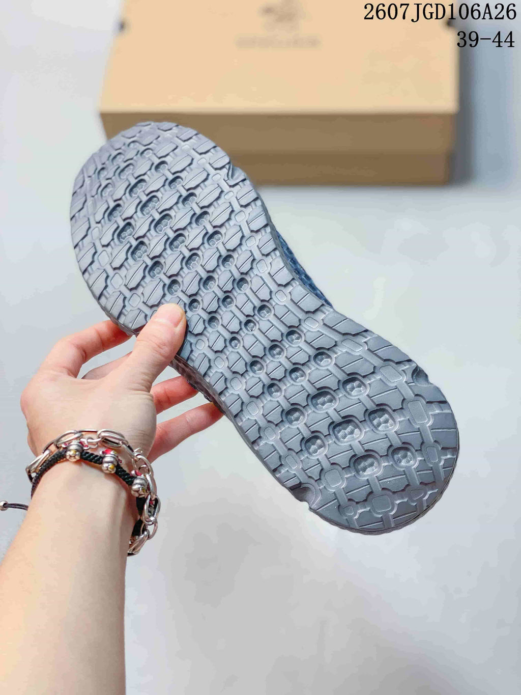 Close view of the sneaker outsole showing its repeating geometric tread pattern.