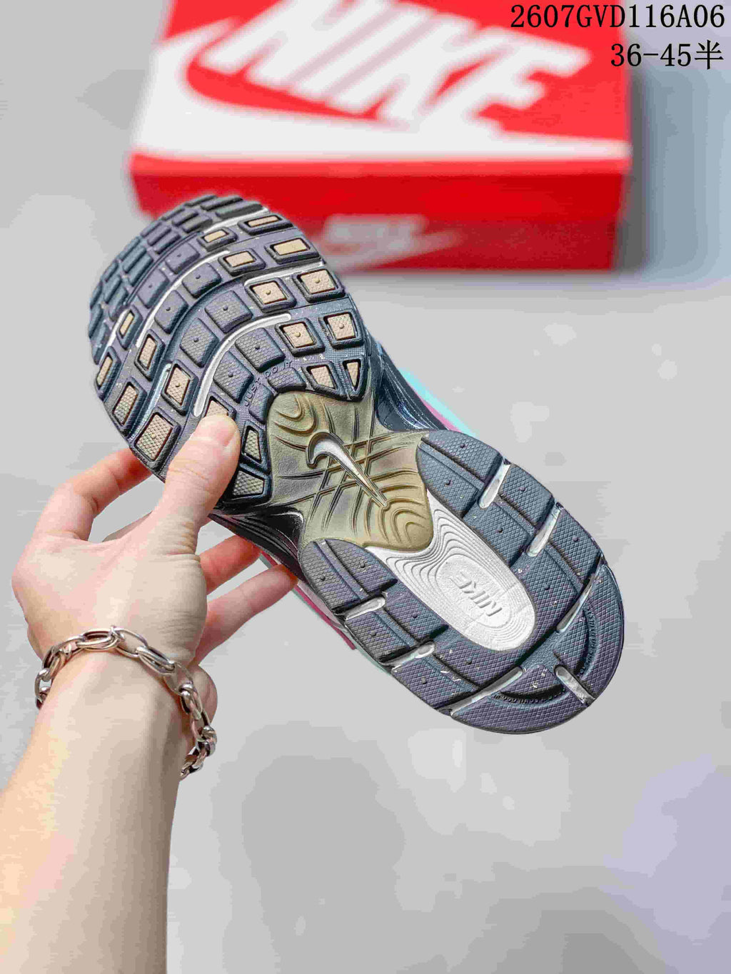 Outsole view of the Nike V5 RNR sneaker showing a dark segmented tread pattern and central Nike branding; image text shows size range 36–45.