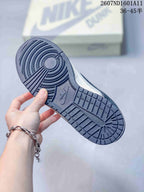 Close-up of the dark rubber outsole showing circular forefoot traction and rectangular tread blocks.