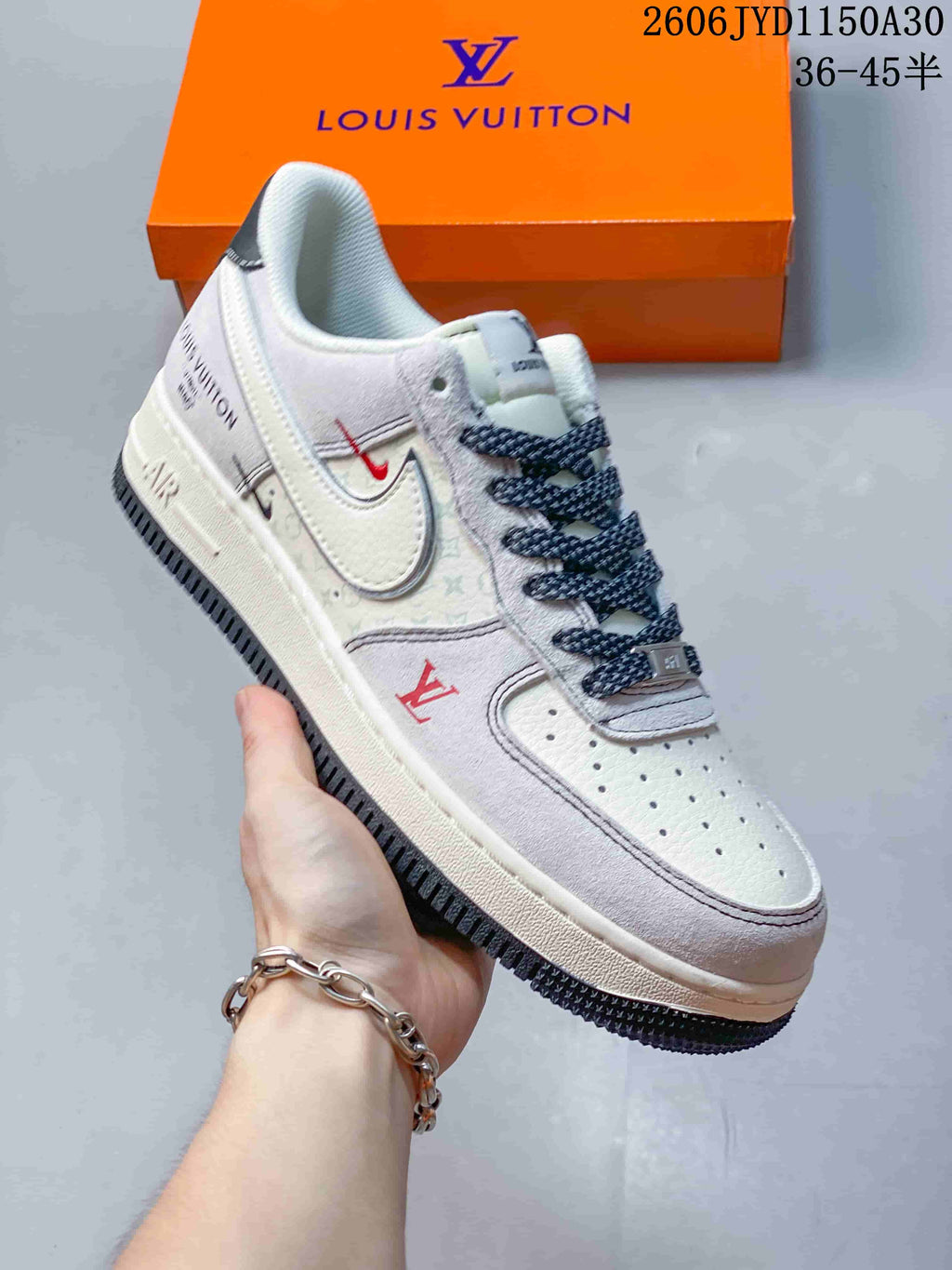 Close view of a white and gray low-top sneaker with patterned laces and dark outsole details