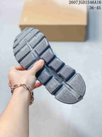 Close view of the gray segmented outsole with rectangular textured pods and a central groove.