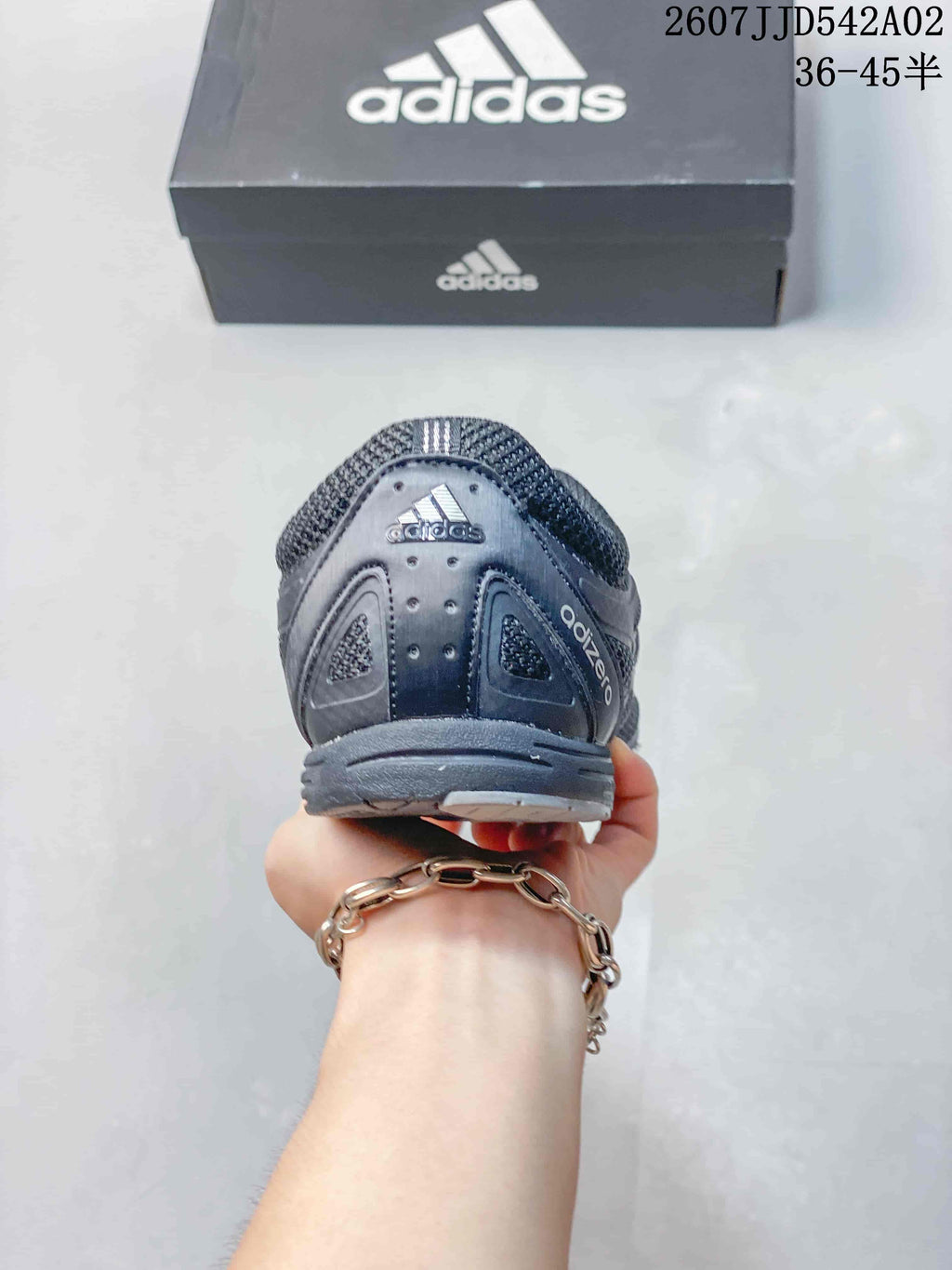 Rear view of the charcoal gray Adidas Adizero PR sneaker