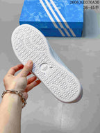 Close-up of the textured outsole on a white Adidas Stan Smith sneaker