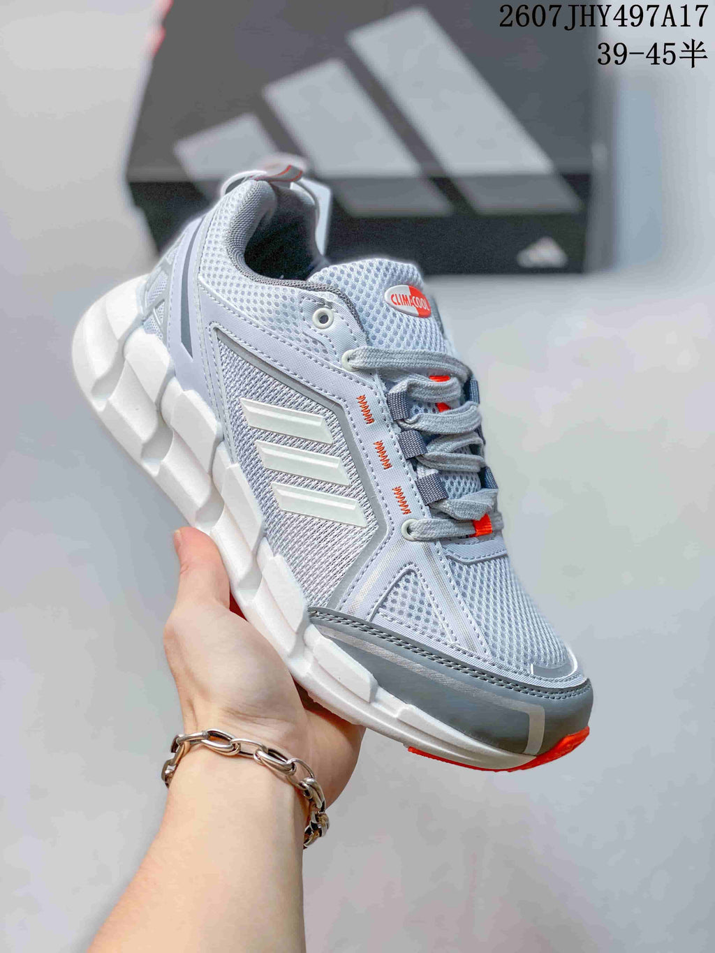 Light gray Adidas Climacool Ventage sneaker with white side stripes and red outsole accents.