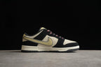 Side profile showing the beige and black upper, muted yellow Swoosh, cream midsole, and black outsole.