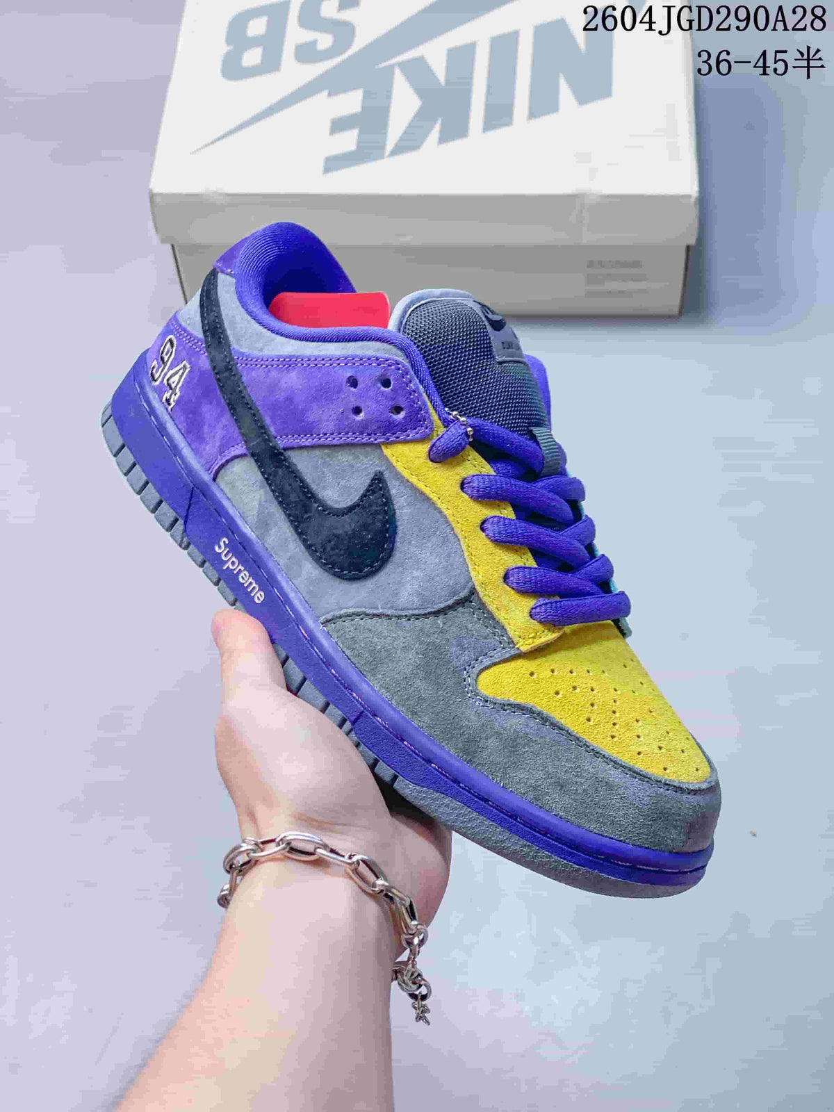 Purple, gray, yellow, and dark-accent Nike Dunk Low sneaker; image overlay shows sizes 36–45.5.