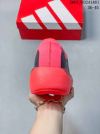 Rear view of the pink Hyperboost Edge shoe with model name on the tongue